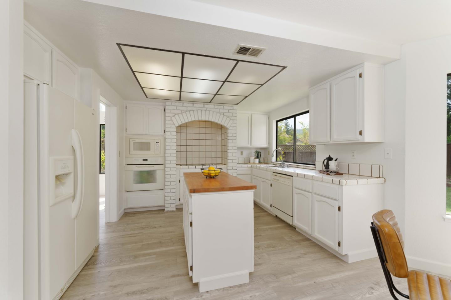 6702 Paseo Catalina Pleasanton, CA 94566 - Photo 16 of 44 a kitchen with white cabinets and white appliances