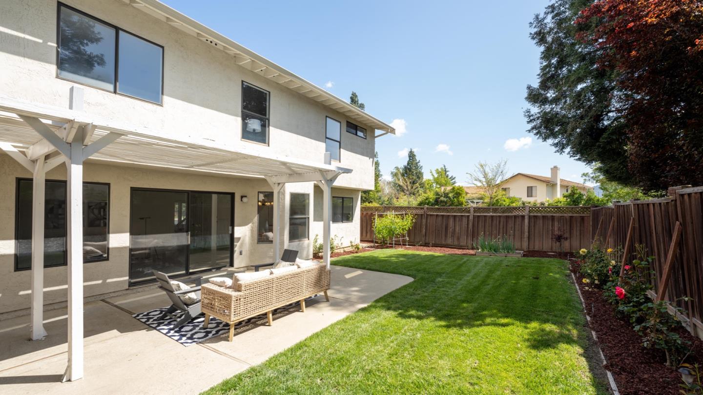 6702 Paseo Catalina Pleasanton, CA 94566 - Photo 39 of 44 a view of a backyard with table and chairs potted plants and wooden fence