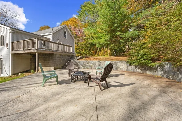 a view of a house with backyard and sitting area