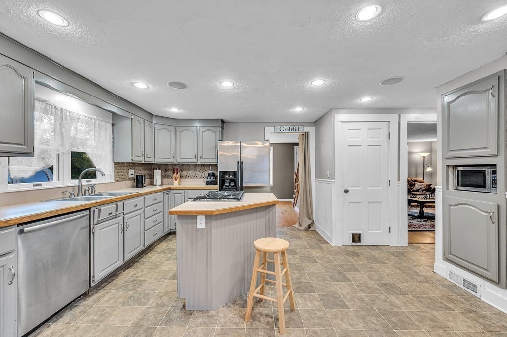 12 Munn Road Monson, MA 01057 - Photo 7 of 40 a large kitchen with stainless steel appliances kitchen island granite countertop a sink and cabinets