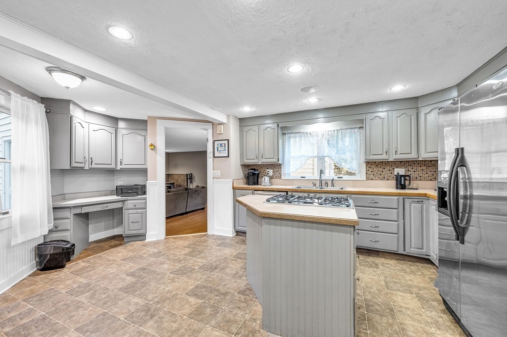 12 Munn Road Monson, MA 01057 - Photo 9 of 40 a kitchen with kitchen island a sink stove and refrigerator