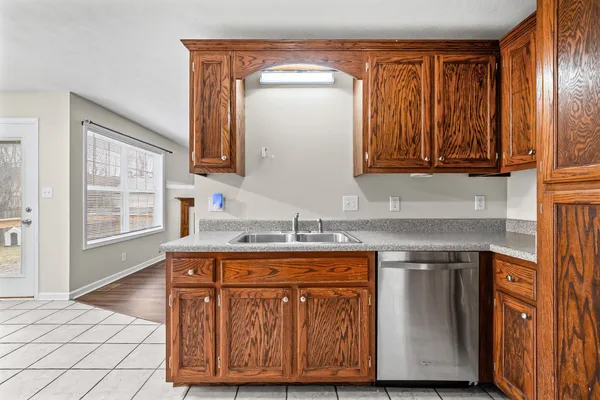 a kitchen with a sink cabinets and a wooden floor