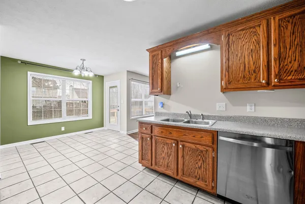 a spacious bathroom with a granite countertop sink and a mirror
