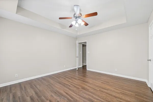 a view of an empty room with wooden floor