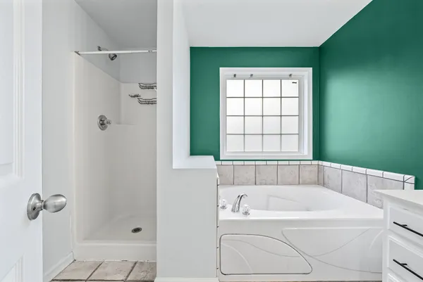 a white bath tub sitting next to a window