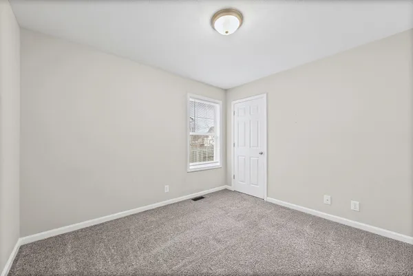 an empty room with a empty space and window