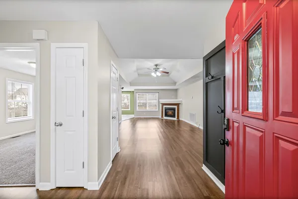 a view of a hallway with wooden floor and staircase