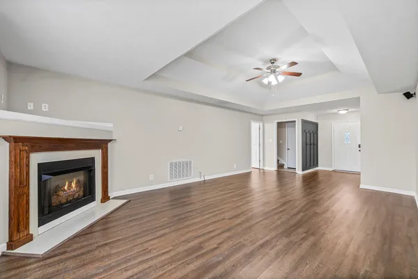a view of an empty room with a fireplace and a window