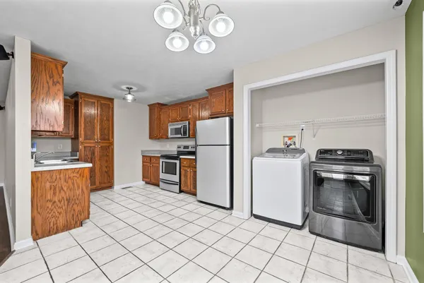 a kitchen with a refrigerator a stove top oven and a sink