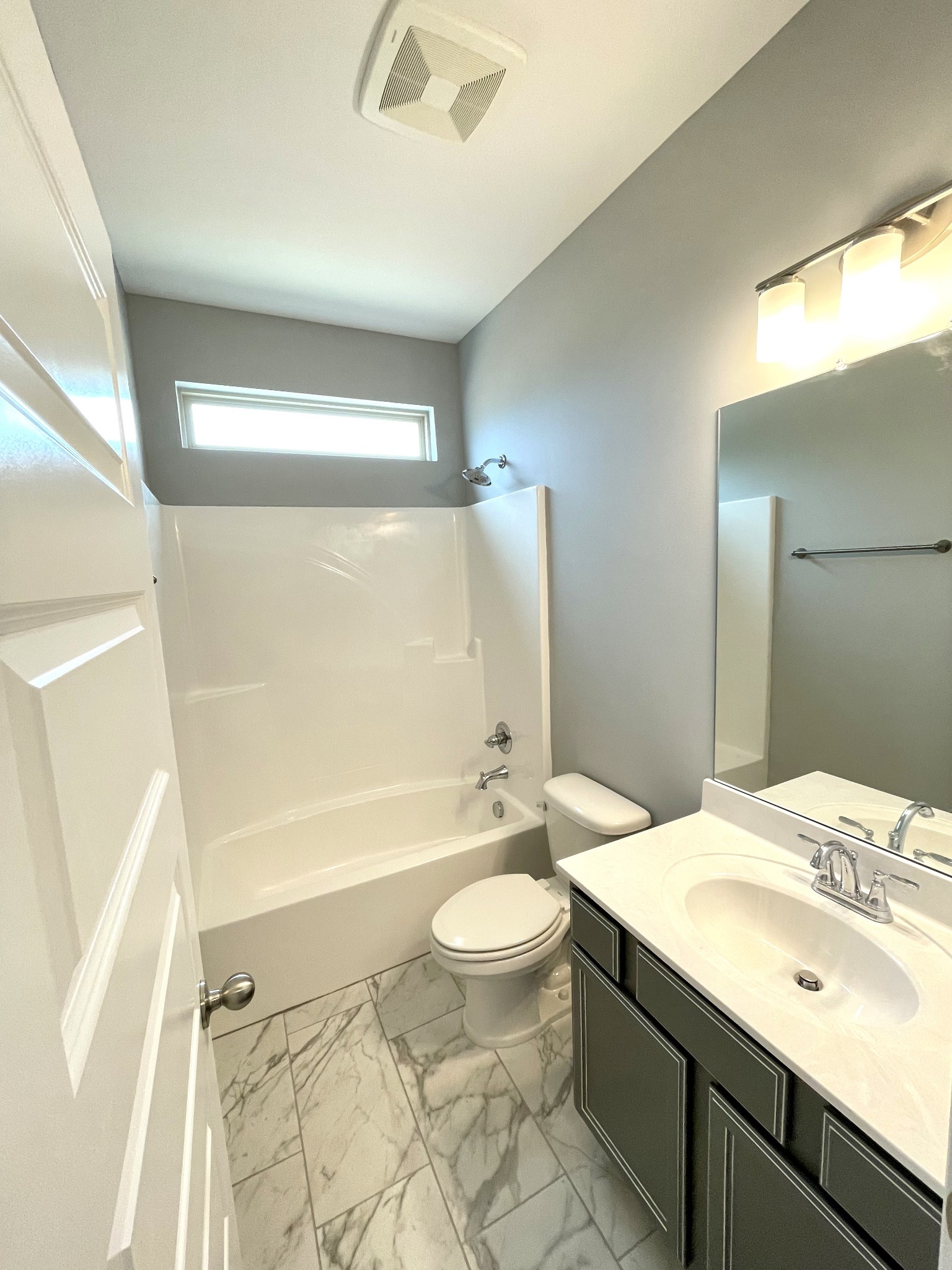 2423 Fig Drive Murfreesboro, TN 37127 - Photo 4 of 37 a bathroom with a sink a toilet a mirror and bathtub