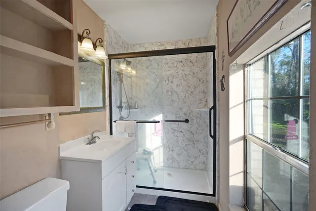 a bathroom with a sink and mirror with bathtub