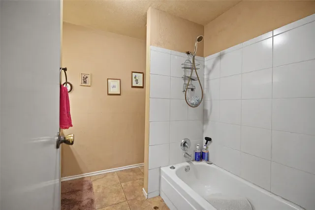 a bathroom with a bathtub and shower