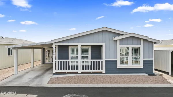 a porch with a table and chairs