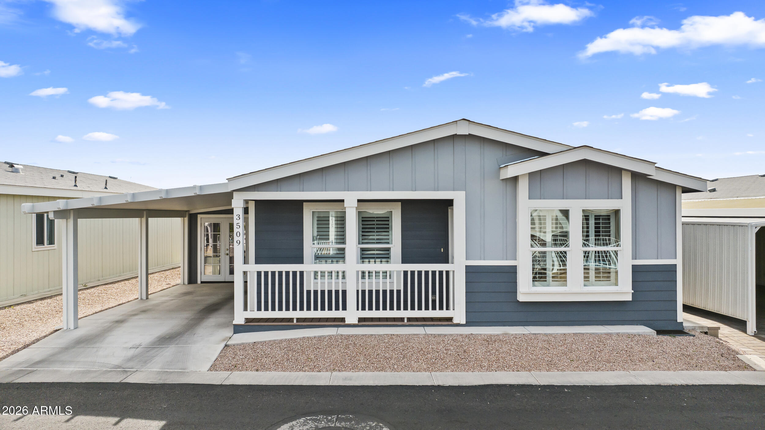 a porch with a table and chairs