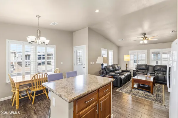 a bathroom with a granite countertop sink toilet and a mirror