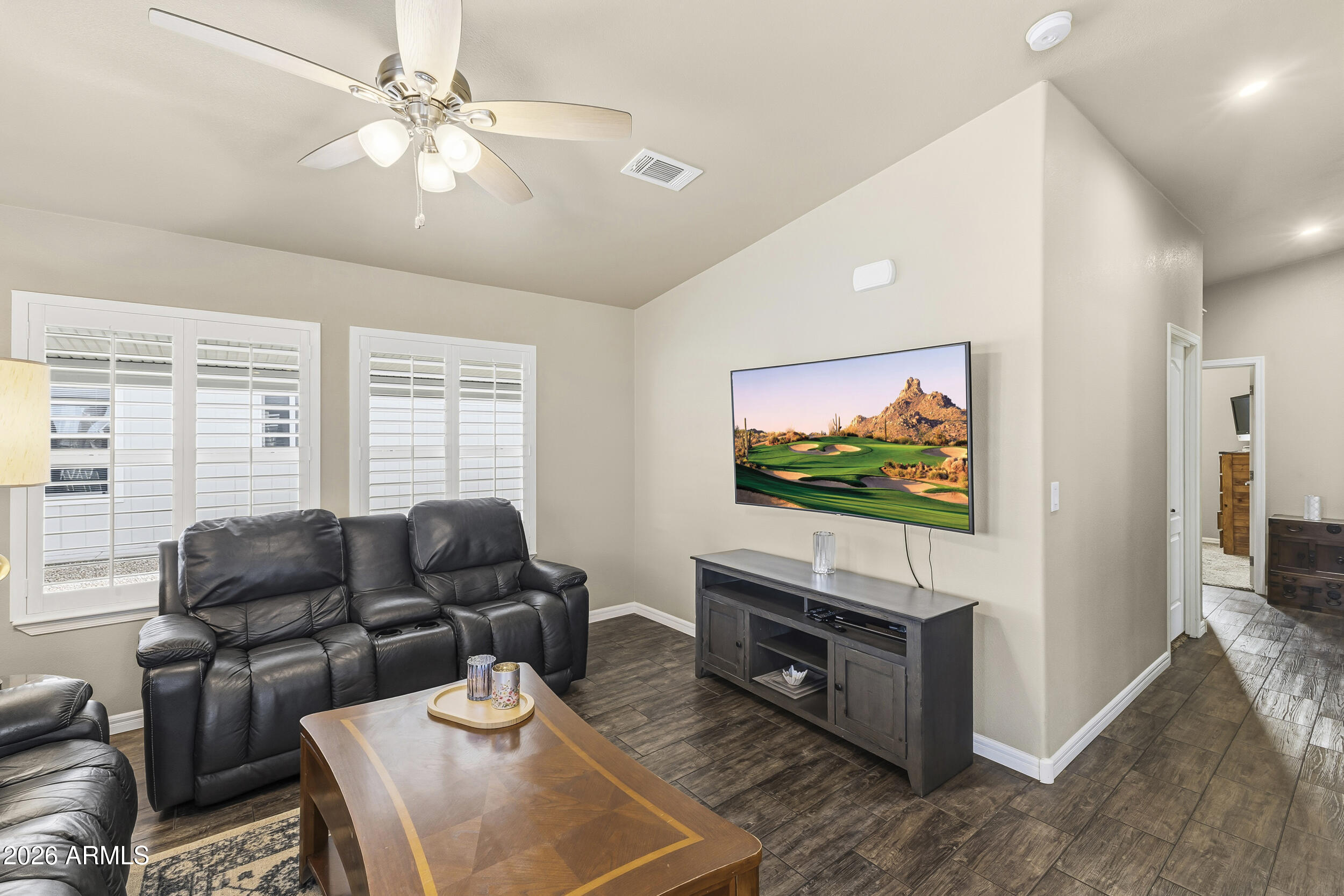 650 North Hawes Road, Unit 3509 Mesa, AZ 85207 - Photo 11 of 43 a living room with furniture and a flat screen tv