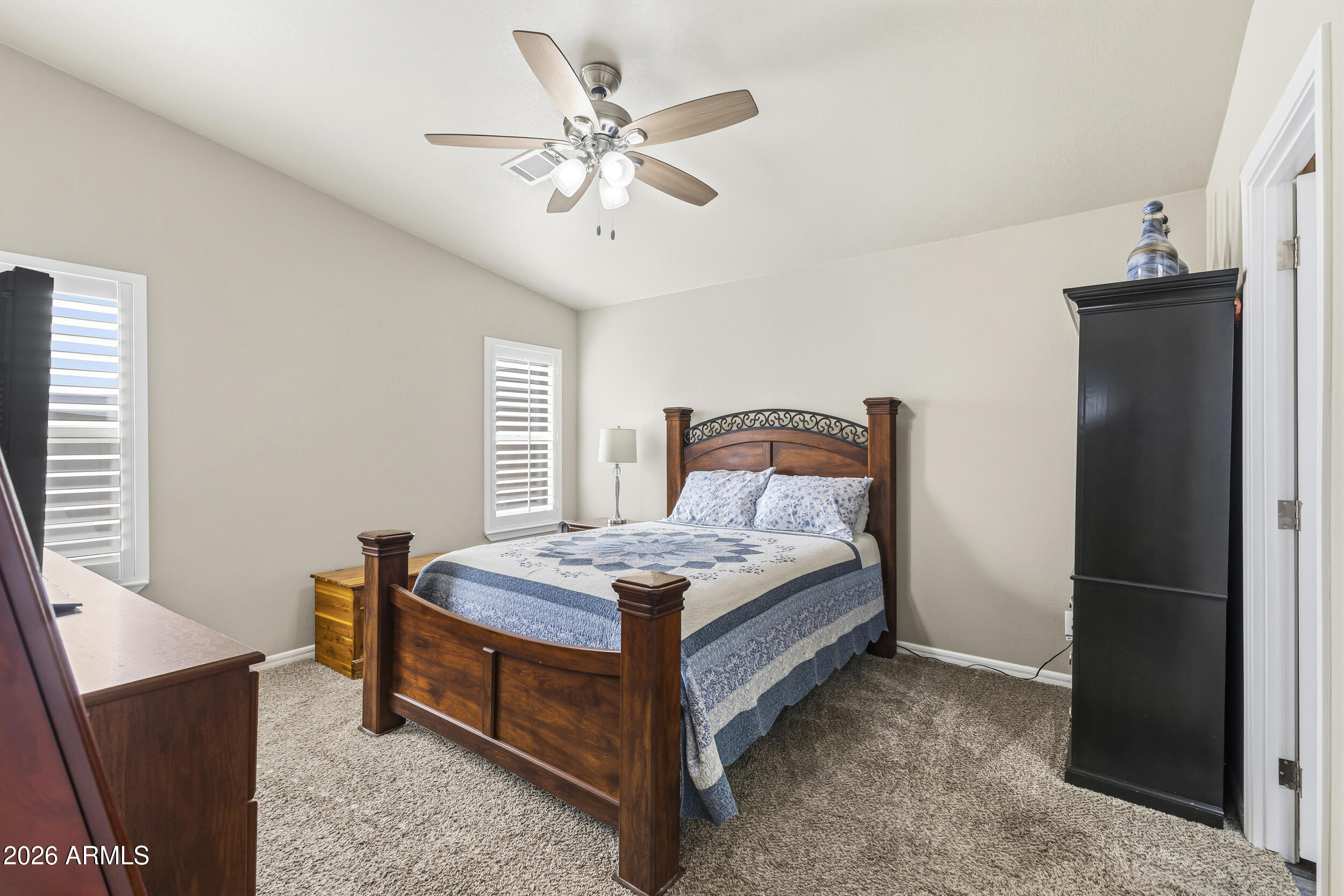 650 North Hawes Road, Unit 3509 Mesa, AZ 85207 - Photo 13 of 43 a bedroom with a bed and a chandelier