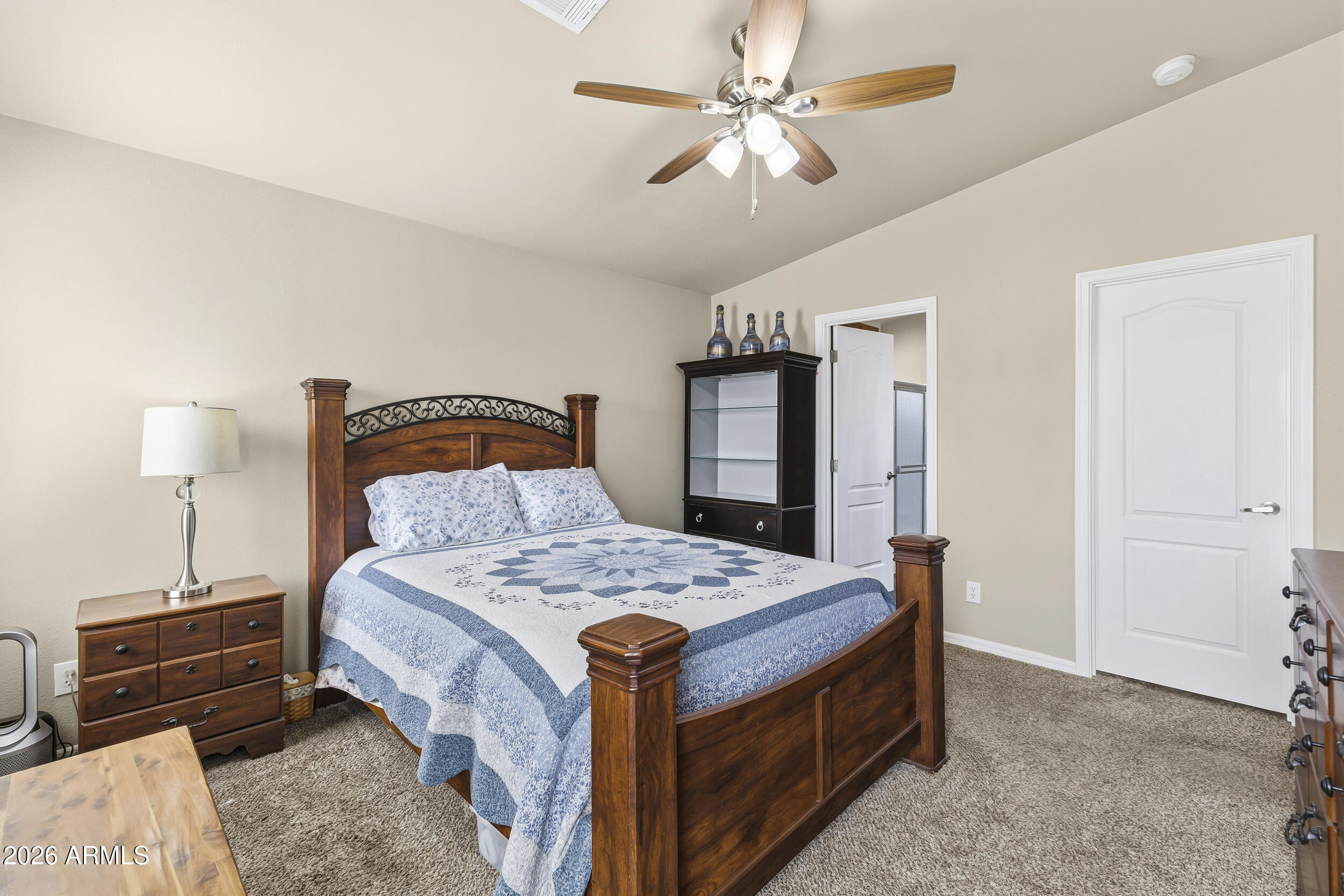 650 North Hawes Road, Unit 3509 Mesa, AZ 85207 - Photo 14 of 43 a bedroom with a bed and a chandelier