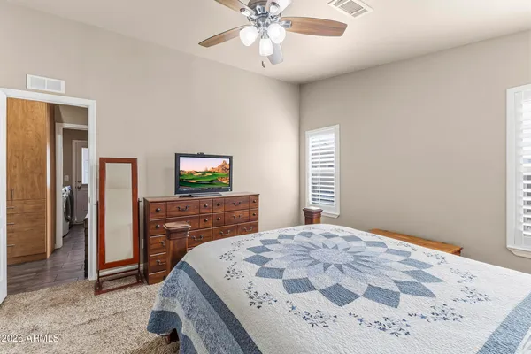 a bedroom with a bed and a chandelier