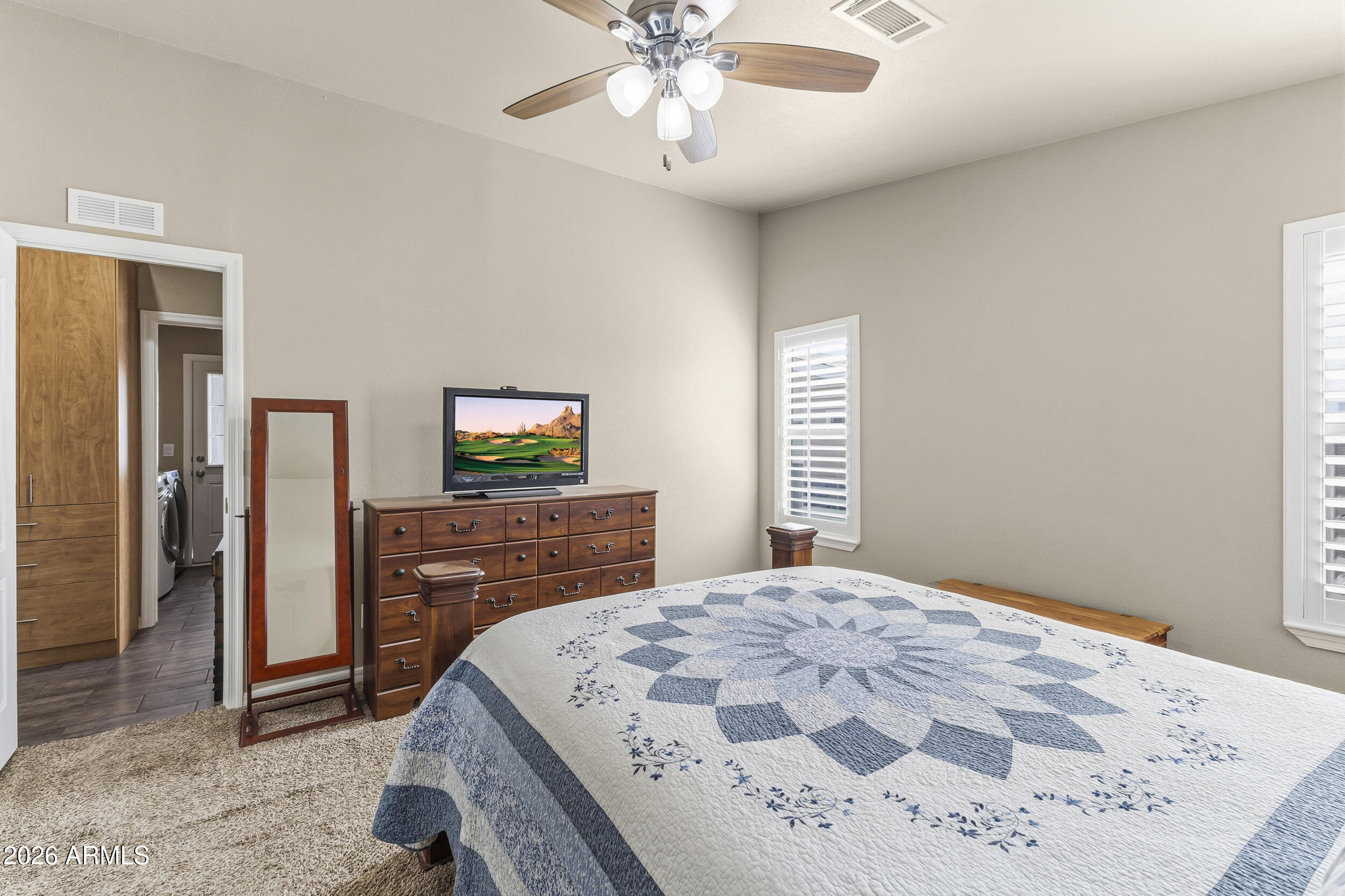 650 North Hawes Road, Unit 3509 Mesa, AZ 85207 - Photo 15 of 43 a bedroom with a bed and a dresser in it