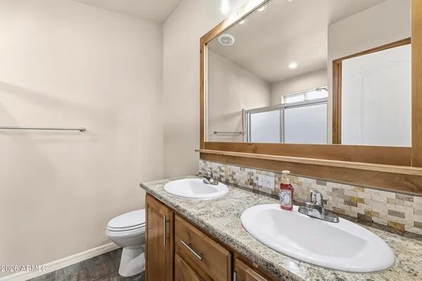 a bedroom with a bed and a dresser in it