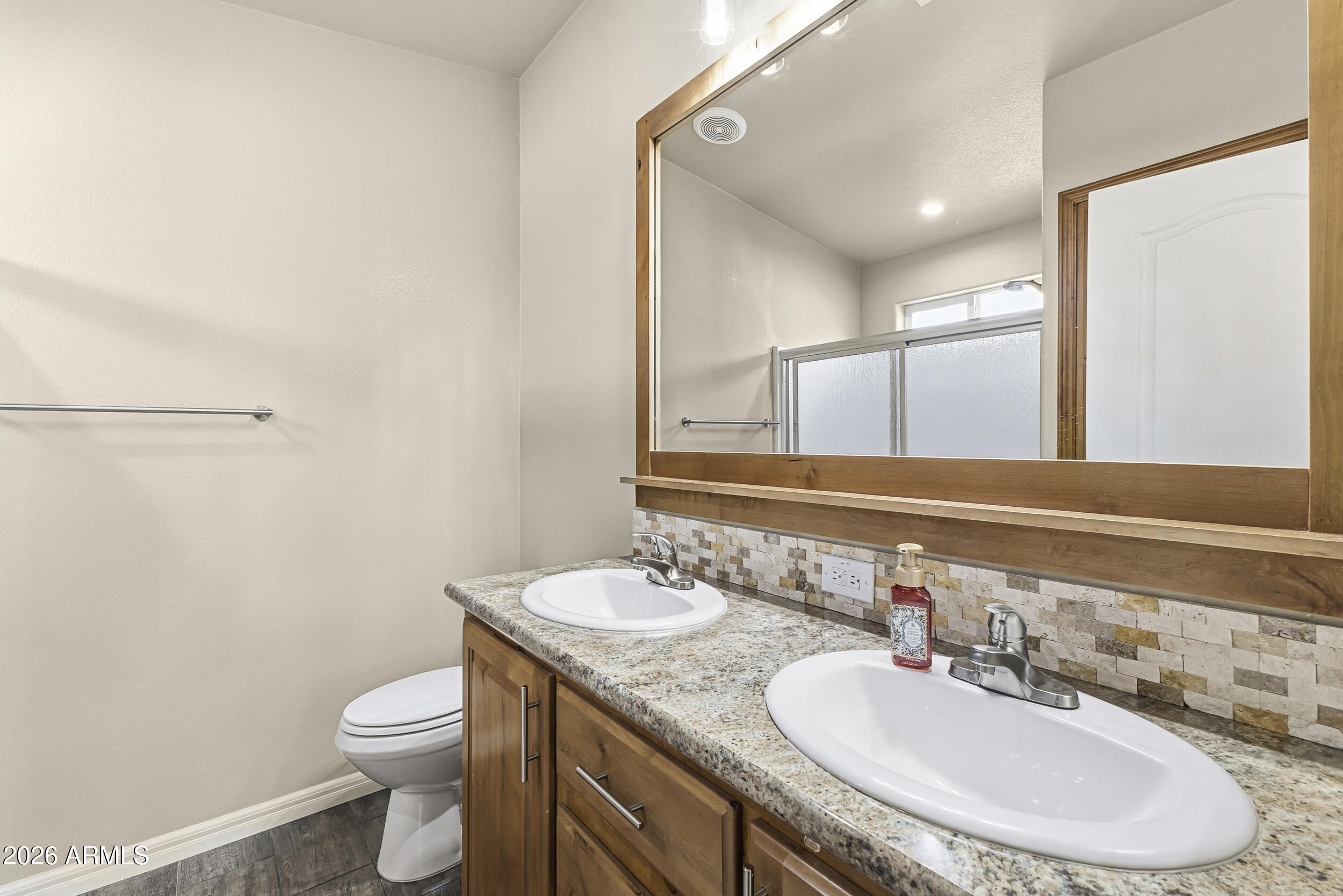 650 North Hawes Road, Unit 3509 Mesa, AZ 85207 - Photo 16 of 43 a bathroom with a granite countertop sink a toilet and a mirror