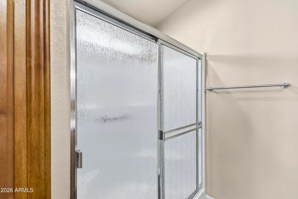 a bathroom with a granite countertop sink a toilet and a mirror