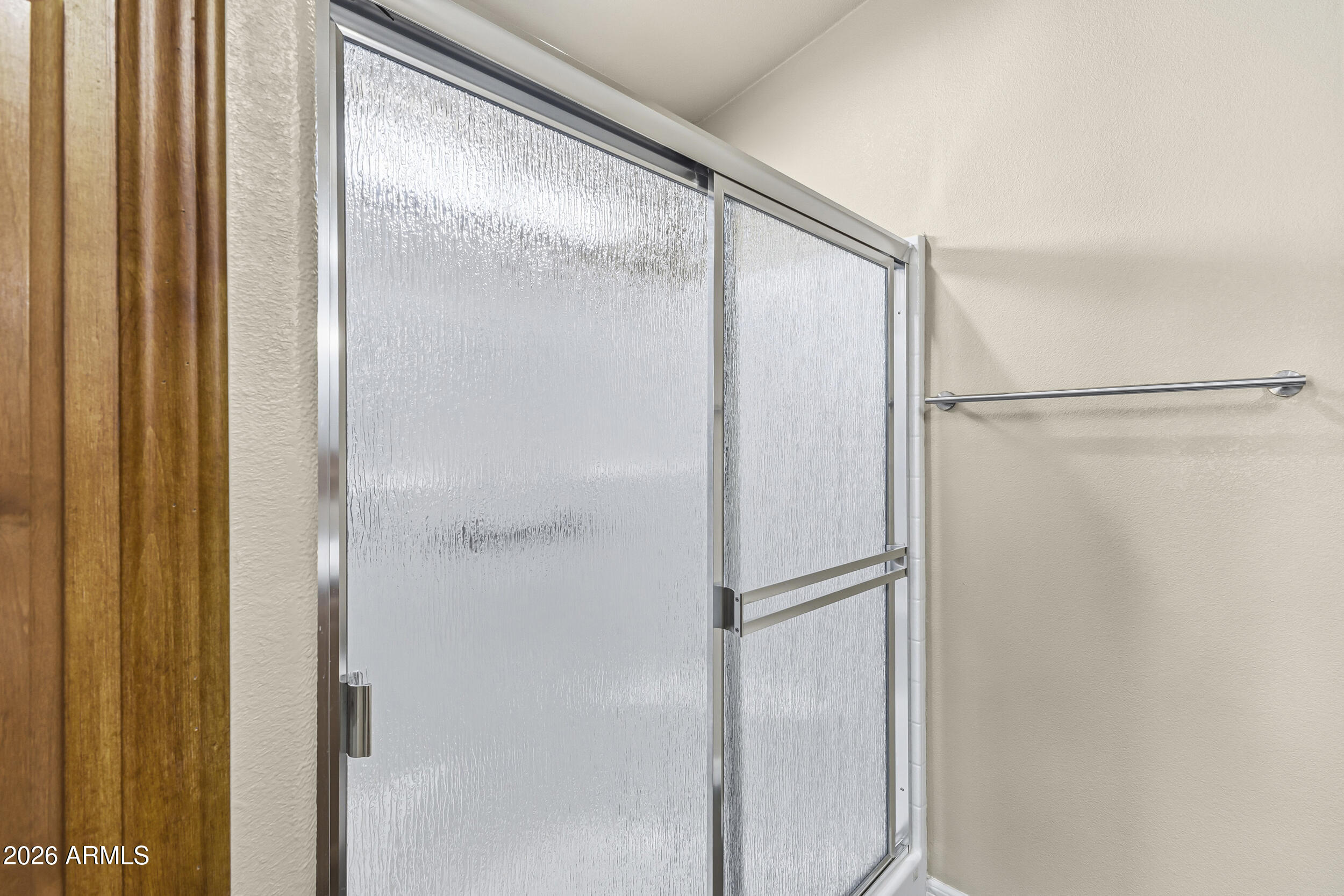 650 North Hawes Road, Unit 3509 Mesa, AZ 85207 - Photo 17 of 43 a bathroom with a glass shower door