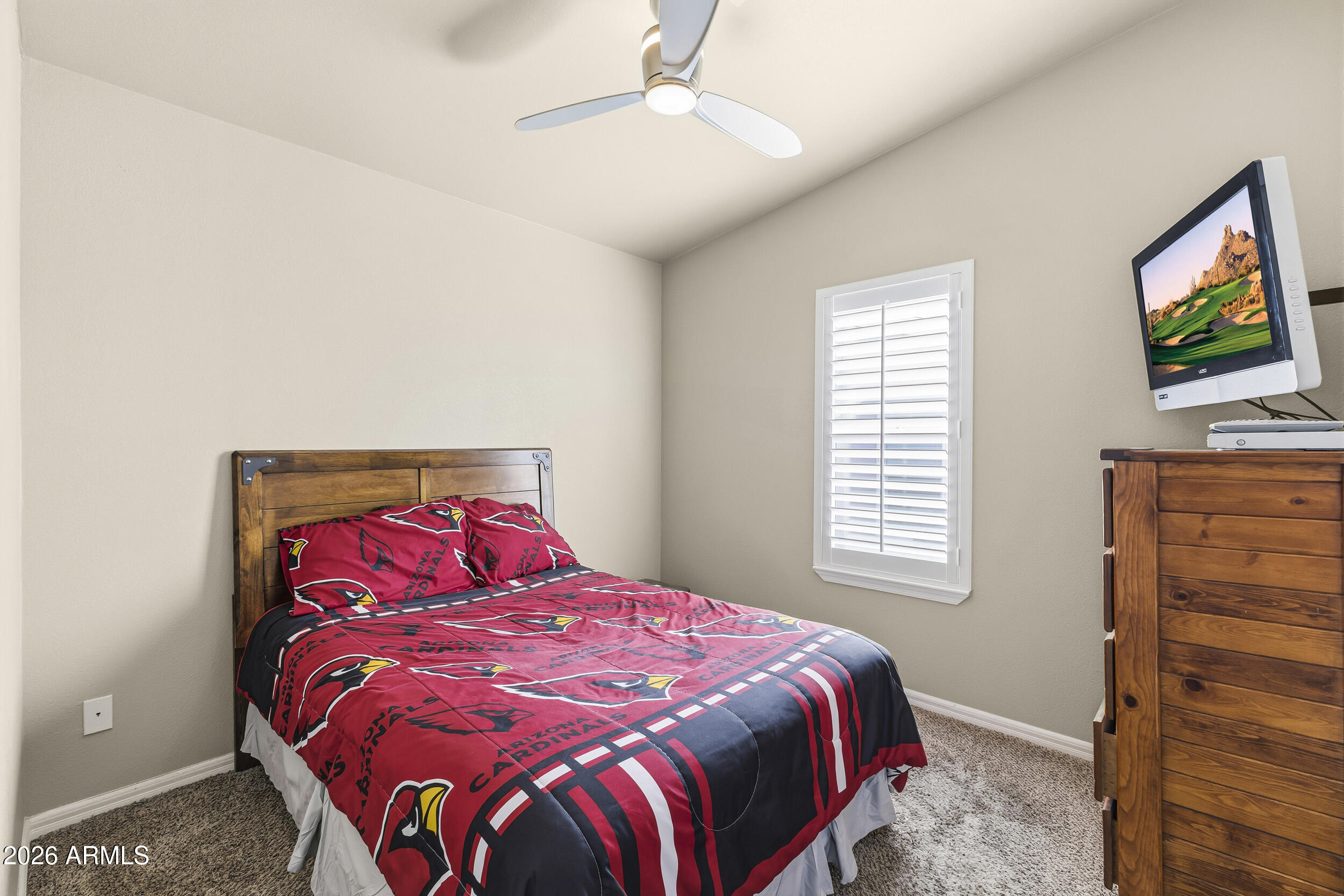 650 North Hawes Road, Unit 3509 Mesa, AZ 85207 - Photo 19 of 43 a bedroom with a bed and a flat screen tv