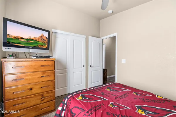 a bedroom with a bed and a flat screen tv