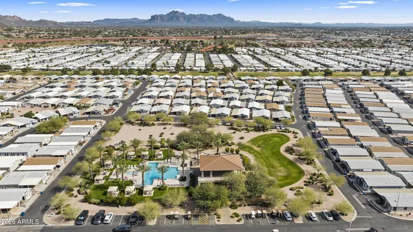 an aerial view of residential houses with outdoor space and trees