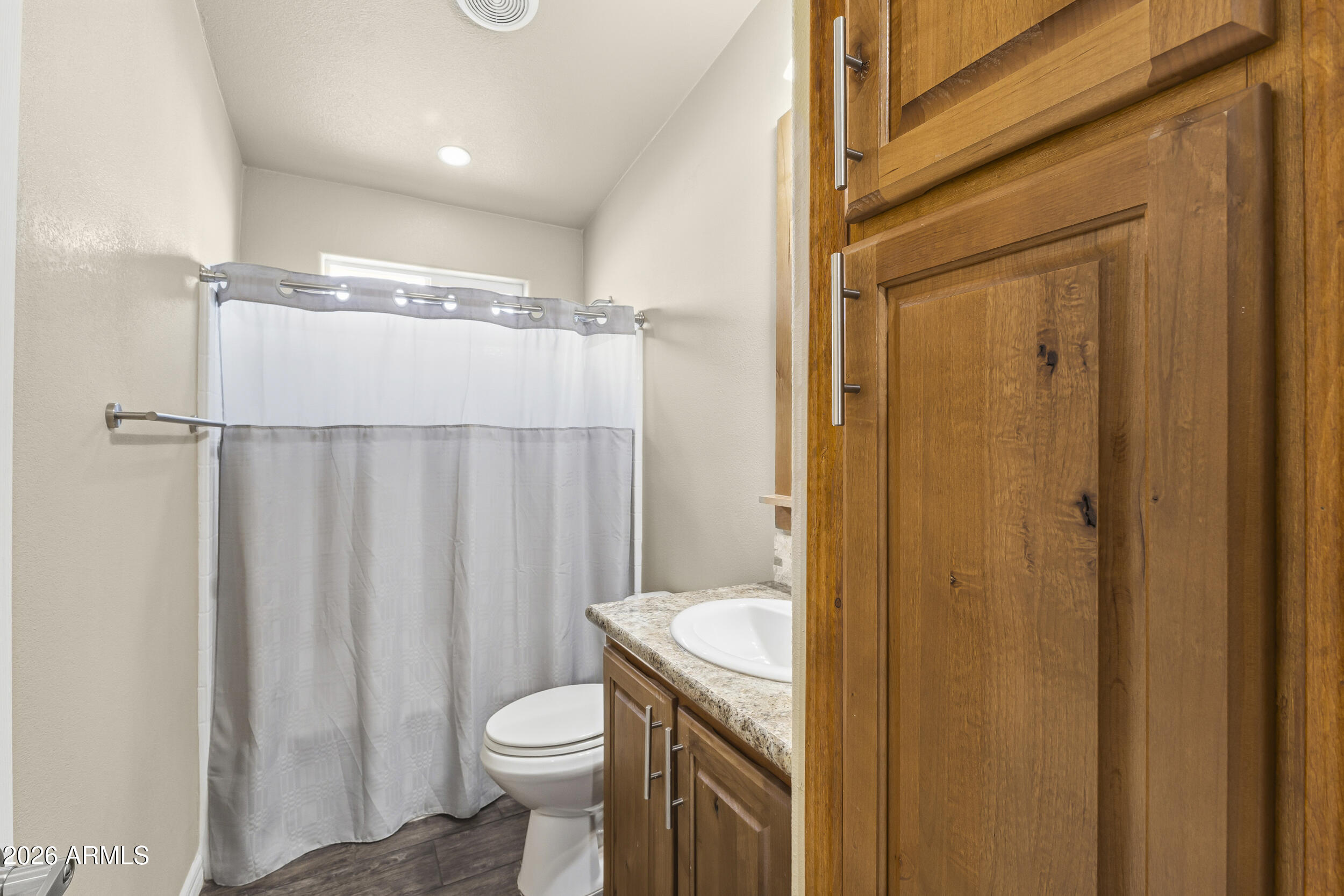 650 North Hawes Road, Unit 3509 Mesa, AZ 85207 - Photo 8 of 43 a bathroom with a granite countertop sink toilet and shower