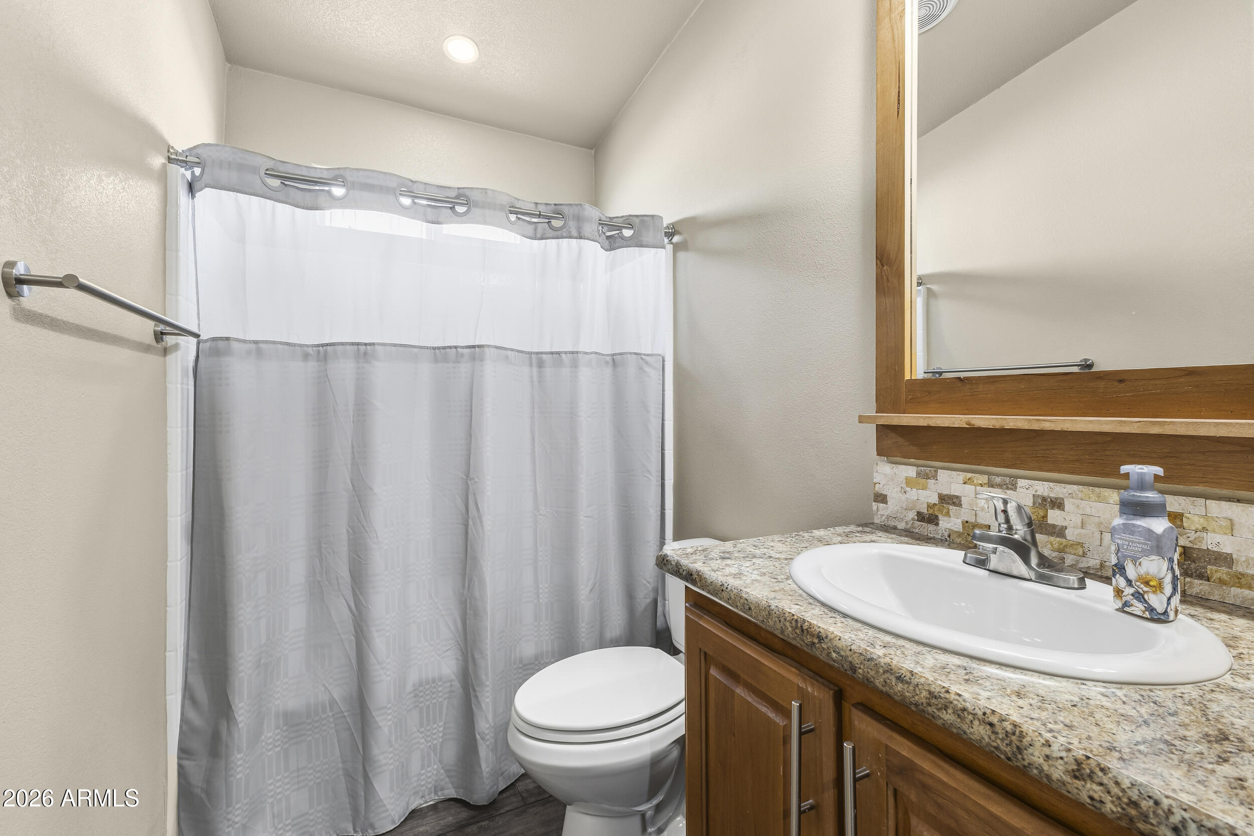 650 North Hawes Road, Unit 3509 Mesa, AZ 85207 - Photo 9 of 43 a bathroom with a granite countertop sink toilet and a mirror
