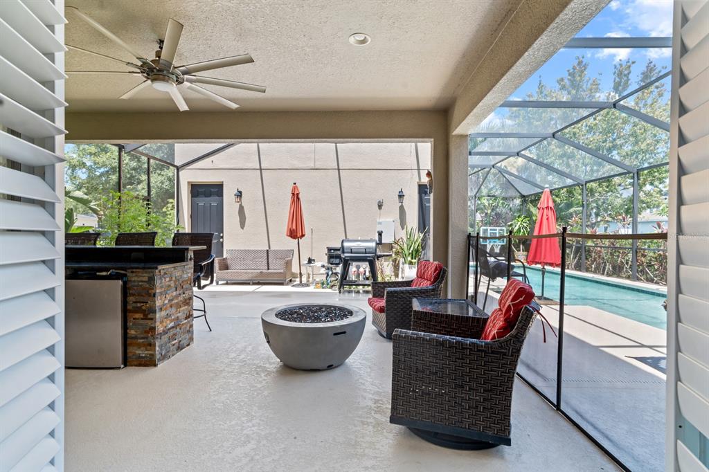 5955 Caldera Ridge Drive Lithia, FL 33547 - Photo 11 of 71 a living room with furniture a fireplace and a chandelier