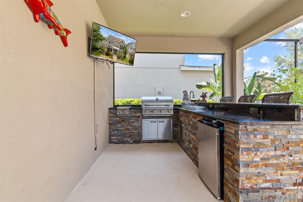 5955 Caldera Ridge Drive Lithia, FL 33547 - Photo 13 of 71 a kitchen with stainless steel appliances a stove a sink and a counter