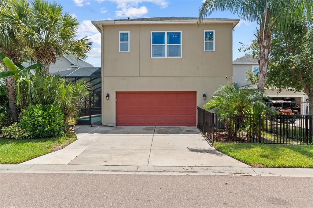 5955 Caldera Ridge Drive Lithia, FL 33547 - Photo 25 of 71 a front view of a house with a yard and garage