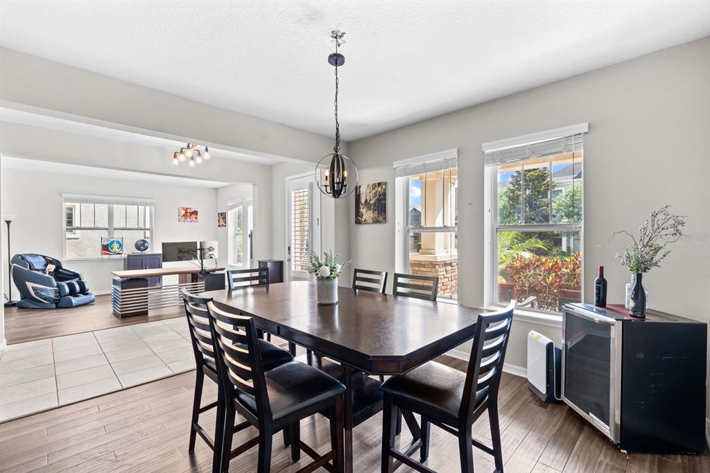 5955 Caldera Ridge Drive Lithia, FL 33547 - Photo 30 of 71 a view of a dining room and livingroom with furniture wooden floor a chandelier