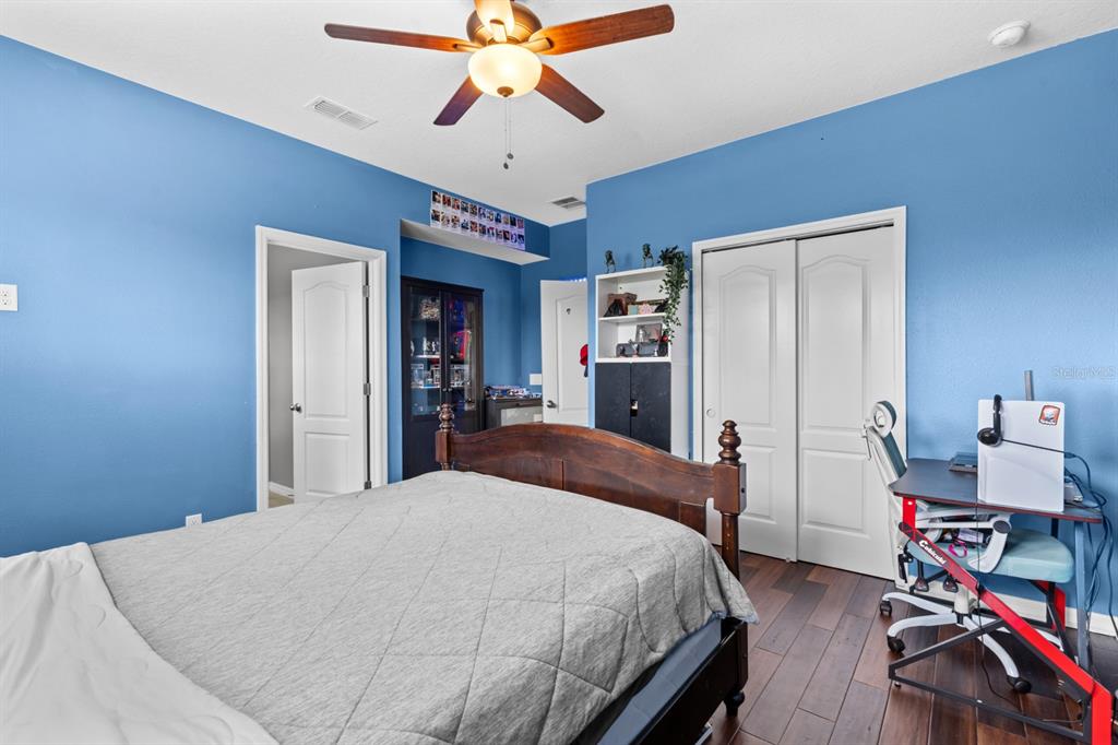 5955 Caldera Ridge Drive Lithia, FL 33547 - Photo 48 of 71 a bedroom with a bed and a chandelier