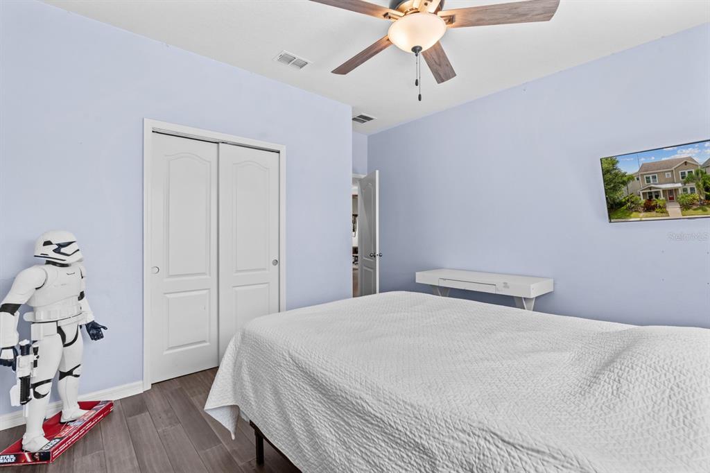 5955 Caldera Ridge Drive Lithia, FL 33547 - Photo 53 of 71 a bedroom with a bed and a chandelier