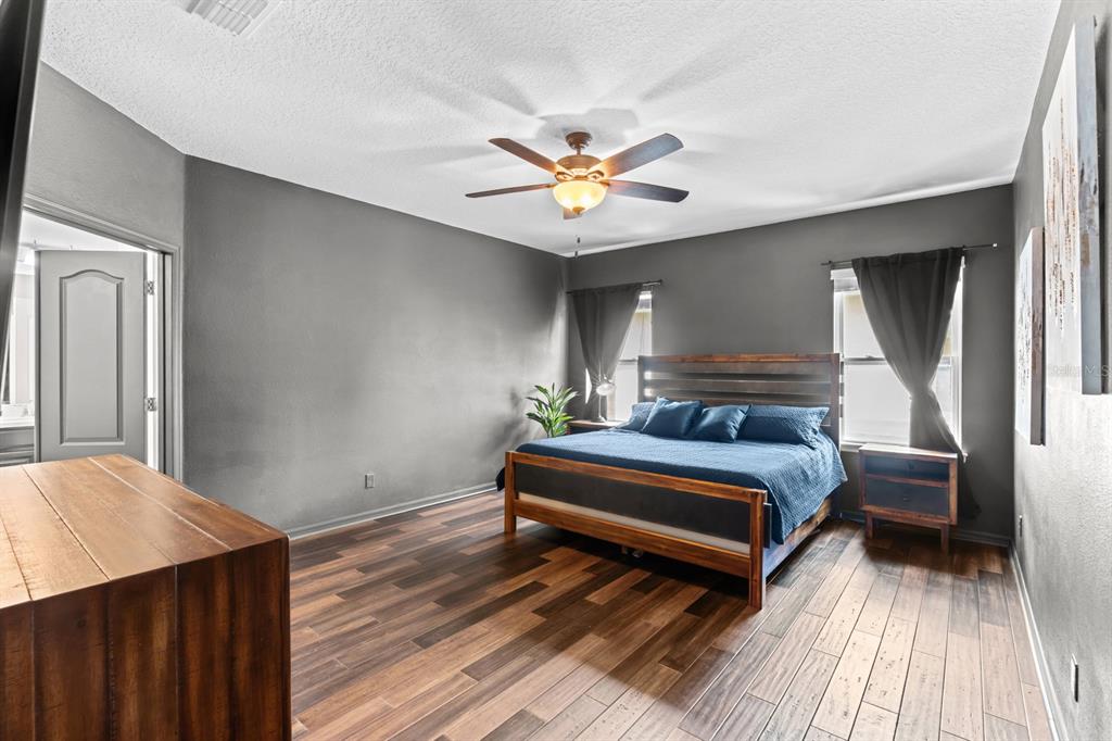 5955 Caldera Ridge Drive Lithia, FL 33547 - Photo 54 of 71 a bedroom with a bed and a chandelier