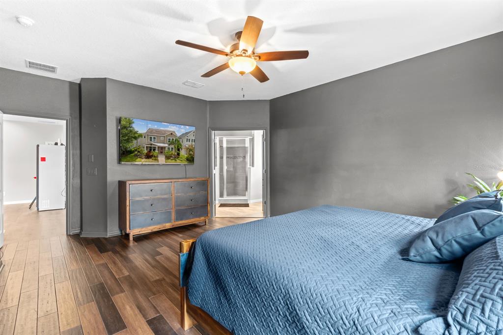 5955 Caldera Ridge Drive Lithia, FL 33547 - Photo 55 of 71 a bedroom with a bed and a flat screen tv