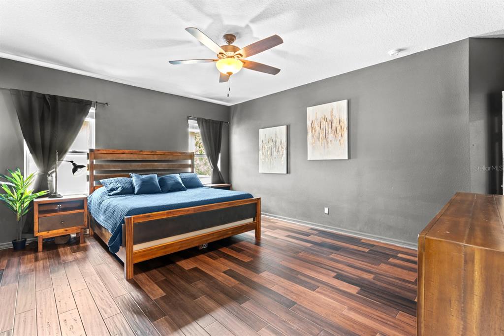 5955 Caldera Ridge Drive Lithia, FL 33547 - Photo 57 of 71 a bedroom with a bed and a chandelier