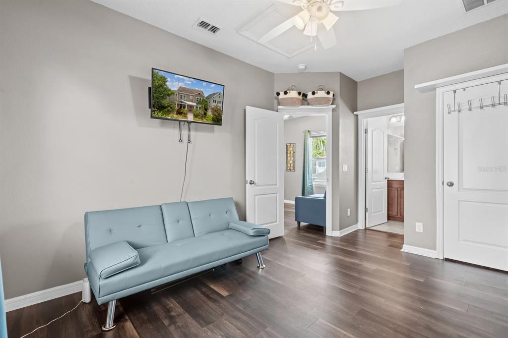 5955 Caldera Ridge Drive Lithia, FL 33547 - Photo 70 of 71 a living room with furniture and a chandelier