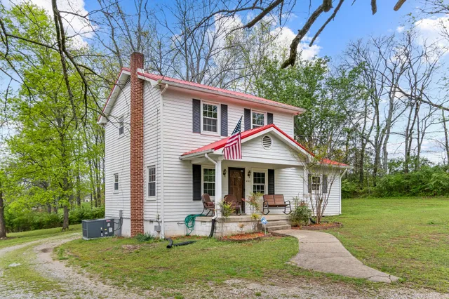 a front view of a house with garden and porch