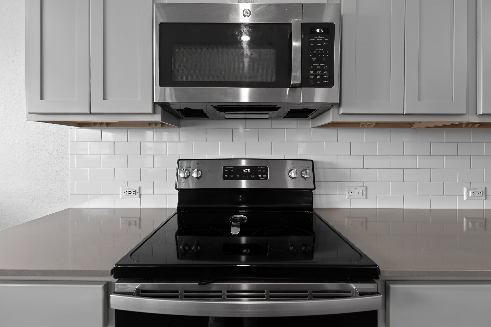 576 Greatest Gift Way Jarrell, TX 76537 - Photo 16 of 37 A sleek, modern kitchen boasts stainless steel appliances and a clean subway tile backsplash.