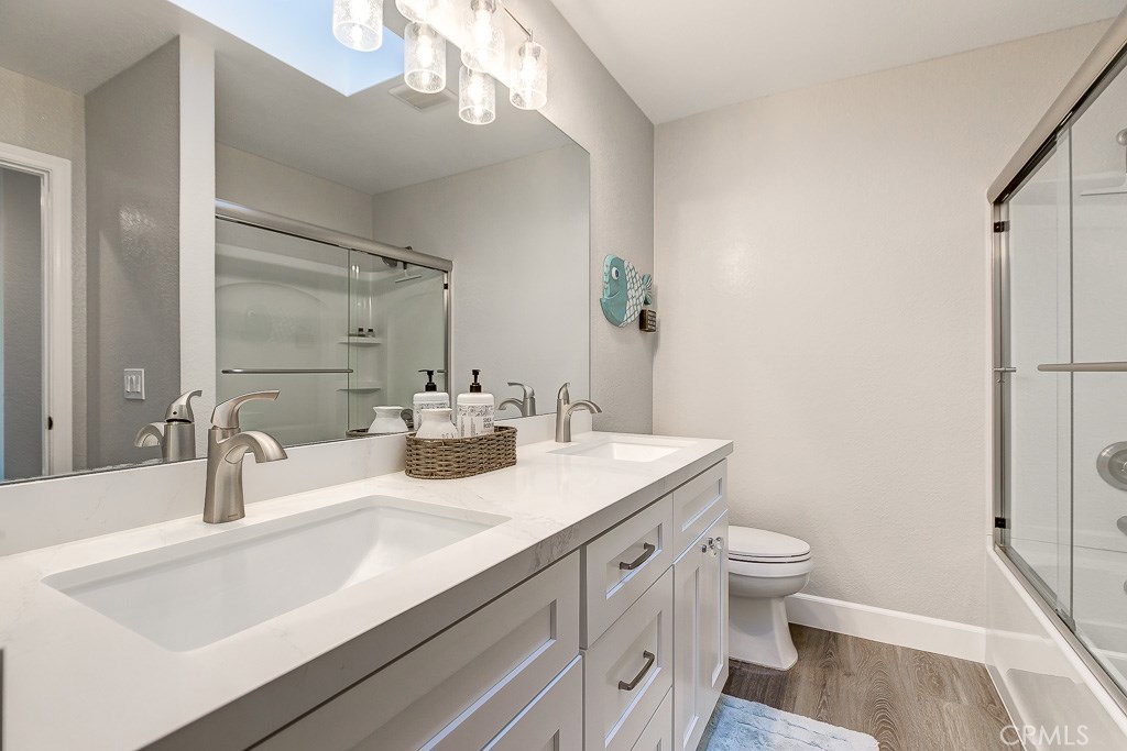 33531 Marlinspike Drive Dana Point, CA 92629 - Photo 16 of 52 a bathroom with a sink vanity granite toilet and a mirror