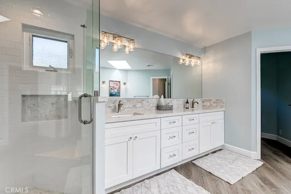 a bathroom with a double vanity sink and a mirror