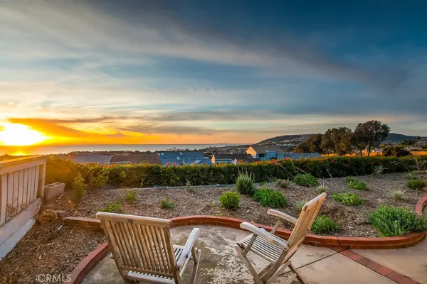 a view of a backyard with sitting area
