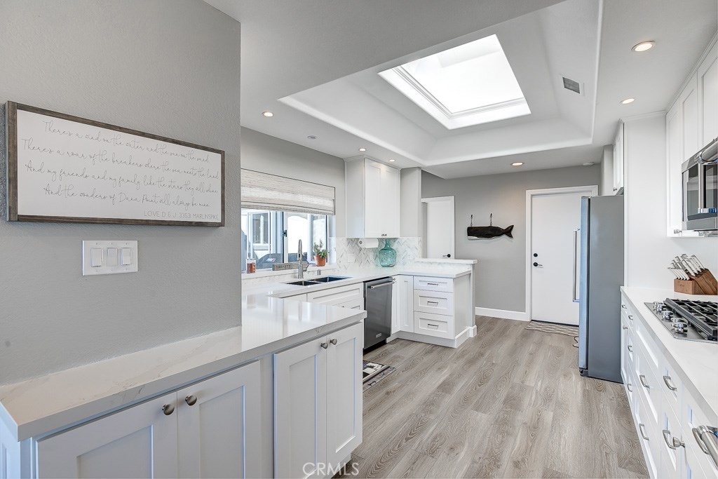 33531 Marlinspike Drive Dana Point, CA 92629 - Photo 10 of 52 a kitchen with white cabinets and window