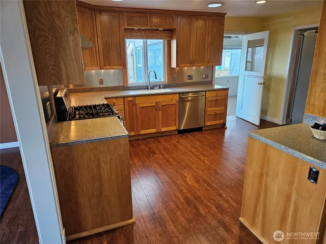 a stove top oven sitting inside of a kitchen